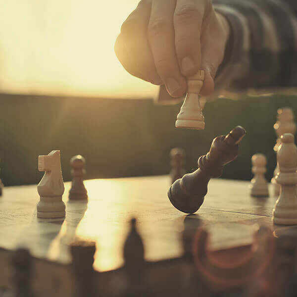 side view of knocking over king in chess